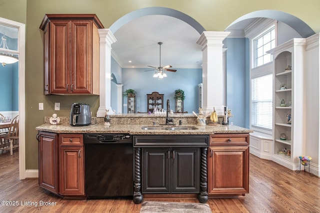 kitchen with ceiling fan, arched walkways, a sink, and black dishwasher