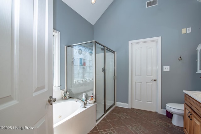 full bathroom featuring toilet, a stall shower, visible vents, a garden tub, and vanity
