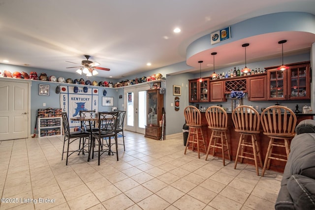 dining room featuring indoor bar, recessed lighting, ceiling fan, and light tile patterned floors