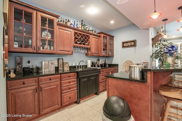 bar featuring a sink, recessed lighting, indoor wet bar, light tile patterned floors, and hanging light fixtures