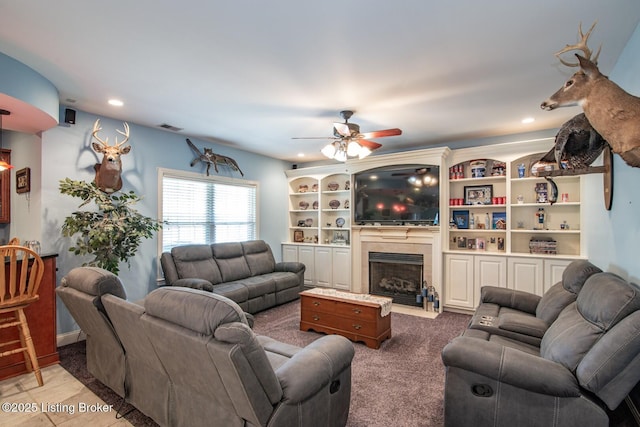 living room with recessed lighting, a tile fireplace, visible vents, and a ceiling fan