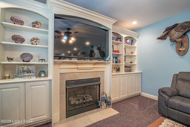 carpeted living area featuring recessed lighting, a tiled fireplace, baseboards, and ceiling fan