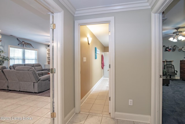hallway featuring light carpet, baseboards, and ornamental molding