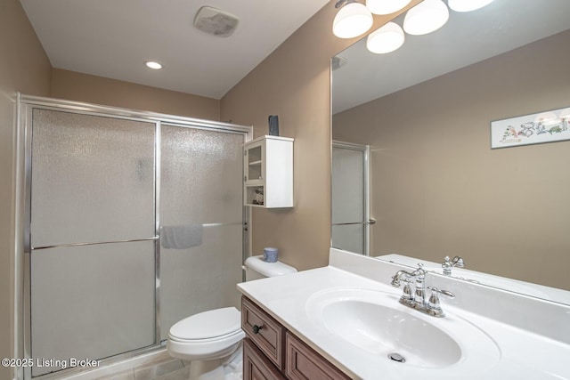 bathroom featuring recessed lighting, a shower stall, toilet, and vanity