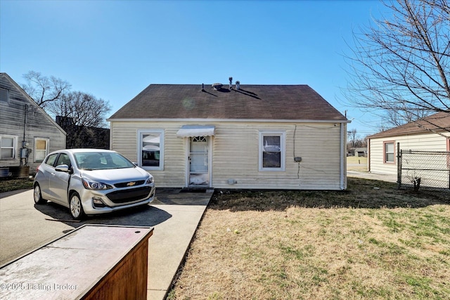 cape cod home featuring a front lawn and fence
