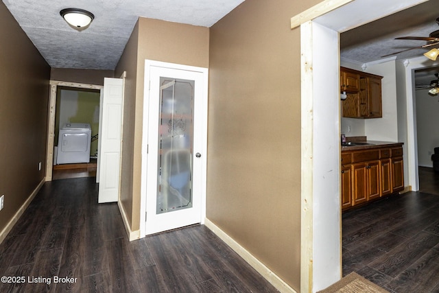 hall with dark wood-type flooring, baseboards, and washer / clothes dryer