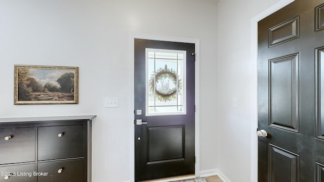 entryway featuring baseboards