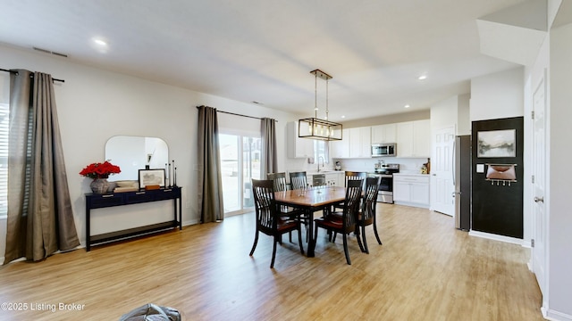 dining space featuring recessed lighting, visible vents, and light wood-style flooring