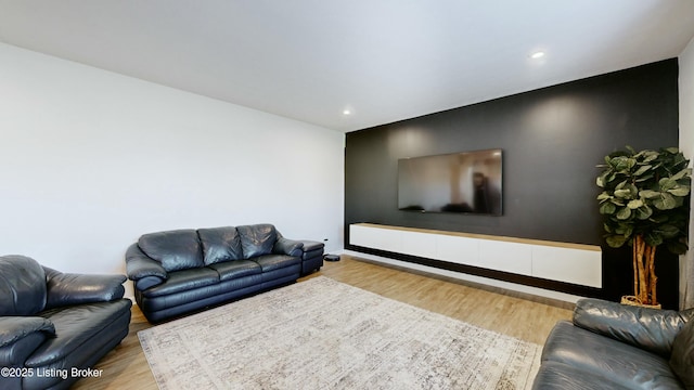living area with recessed lighting, wood finished floors, and baseboards