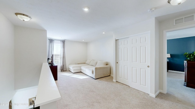 living area with recessed lighting, carpet floors, visible vents, and baseboards