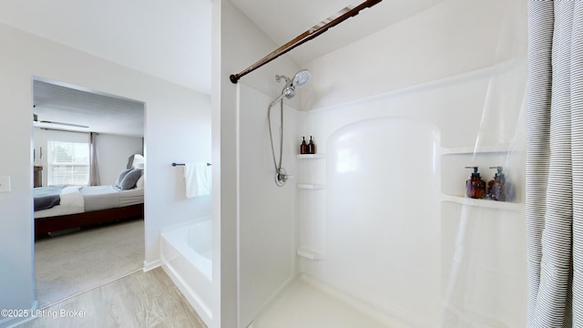 ensuite bathroom featuring ensuite bath and a shower with curtain