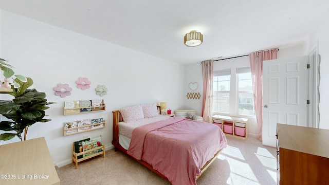 bedroom featuring light colored carpet and baseboards
