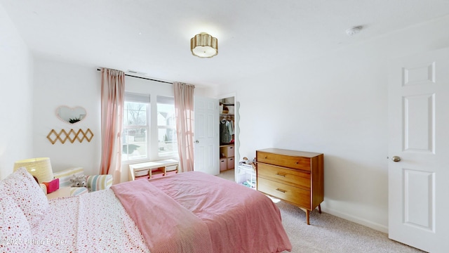 bedroom with baseboards and light colored carpet