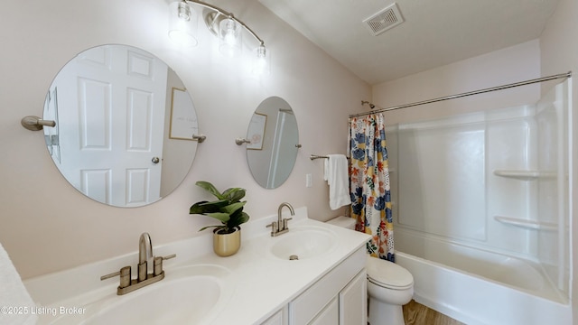 bathroom with visible vents, toilet, shower / bath combo, and a sink