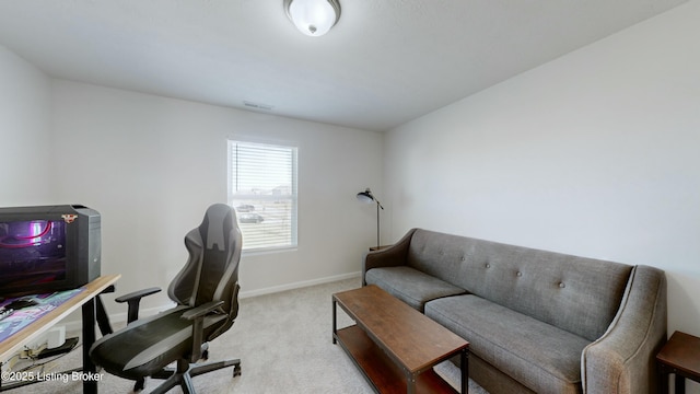 office featuring baseboards and light colored carpet
