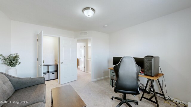 office featuring visible vents, baseboards, and light carpet