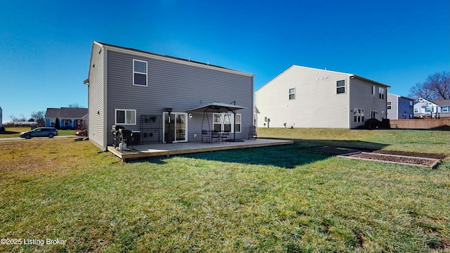 rear view of property featuring a wooden deck and a yard