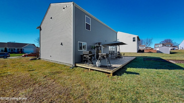 back of property with a lawn and a wooden deck