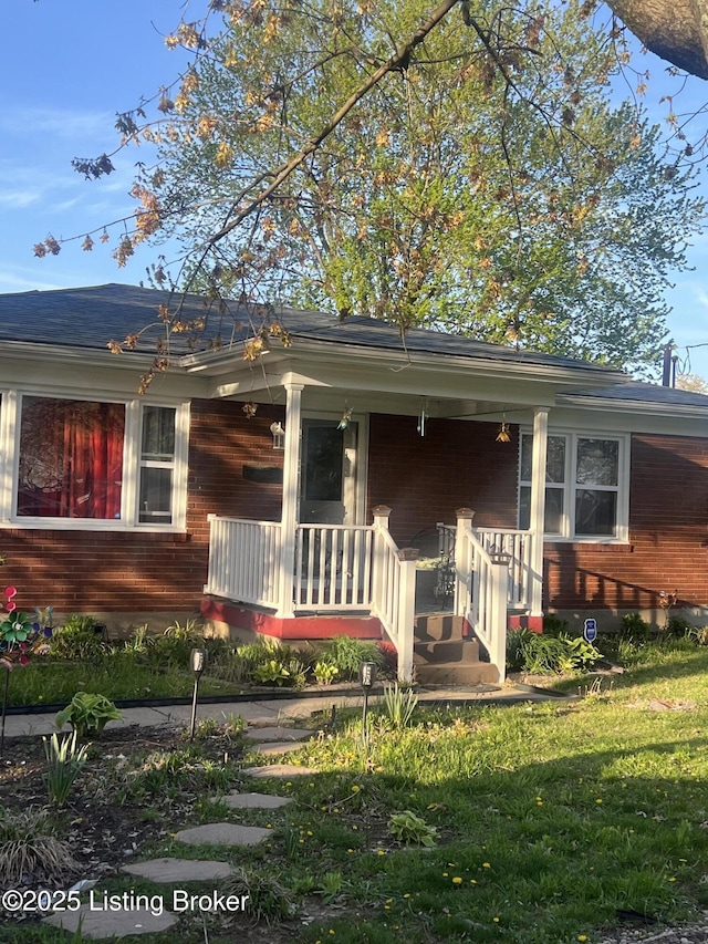 view of front of home with a front lawn and a porch