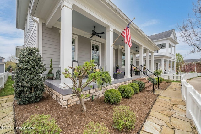 view of home's exterior featuring fence, ceiling fan, and covered porch