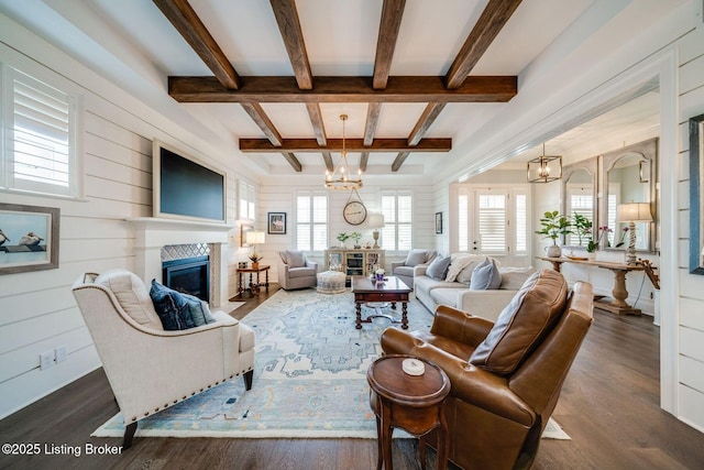 living area with a fireplace with flush hearth, a wealth of natural light, and dark wood-style flooring
