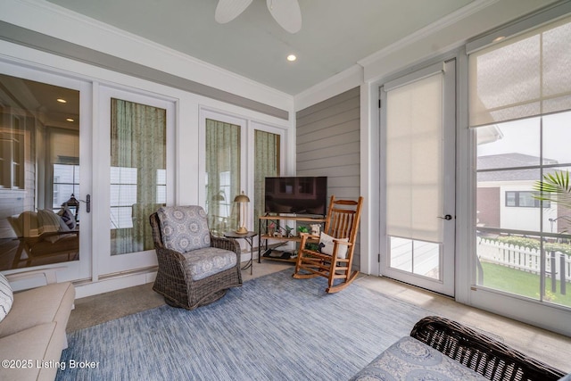 sunroom / solarium featuring a healthy amount of sunlight, carpet flooring, ornamental molding, and french doors