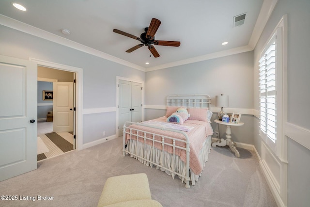 carpeted bedroom with a ceiling fan, crown molding, a closet, visible vents, and recessed lighting