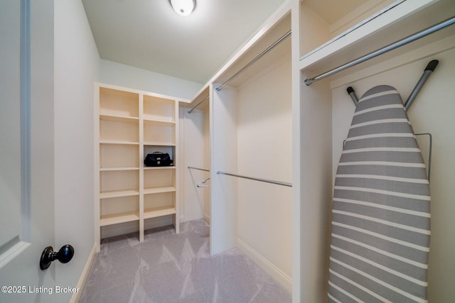 walk in closet featuring carpet floors