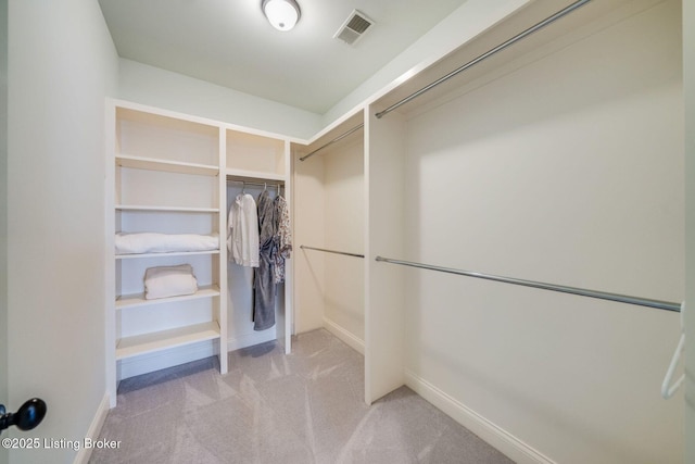 walk in closet with light carpet and visible vents