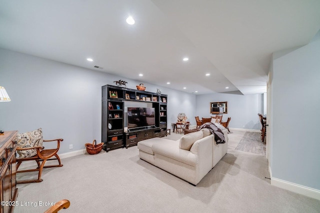 carpeted living room featuring baseboards, visible vents, and recessed lighting