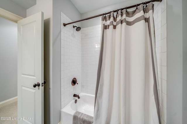 full bathroom featuring baseboards and shower / bath combination with curtain