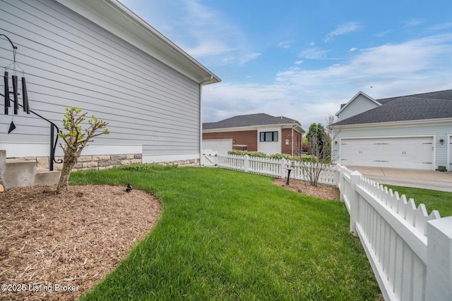 view of yard with fence and a garage