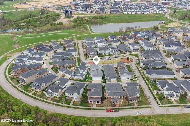 birds eye view of property featuring a water view and a residential view