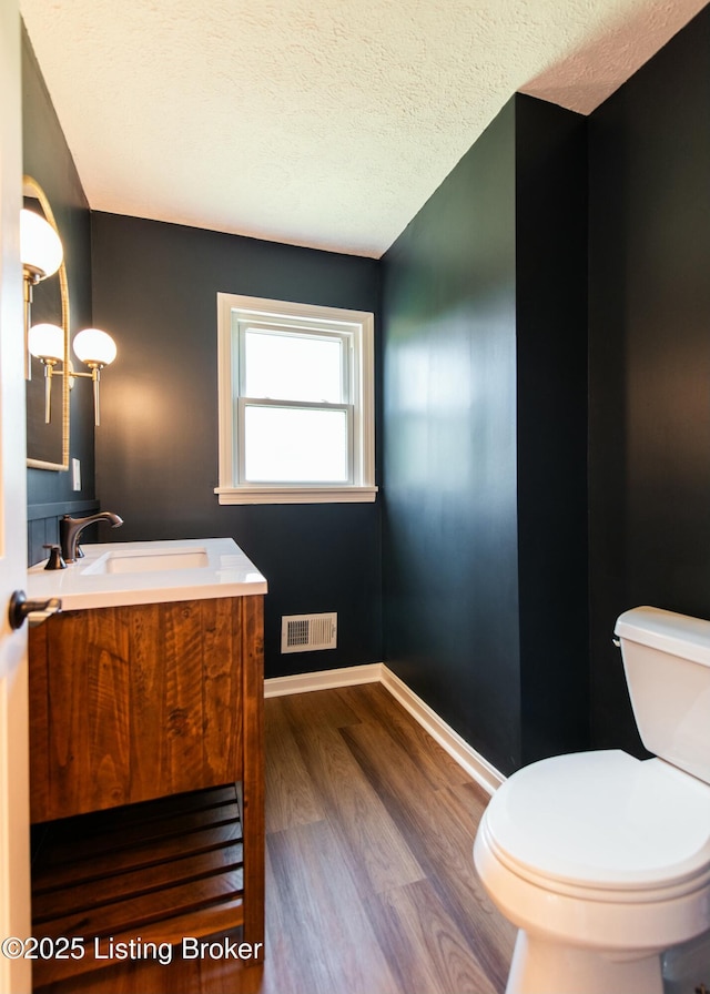 9004 Old Bardstown Rd Rd, Louisville, KY 40291 - bathroom with vanity, wood finished floors, toilet, a textured ceiling, and baseboards