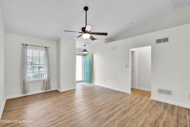 unfurnished room with light wood-type flooring, vaulted ceiling, visible vents, and a ceiling fan