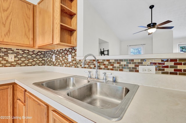 kitchen featuring open shelves, light countertops, a sink, decorative backsplash, and ceiling fan