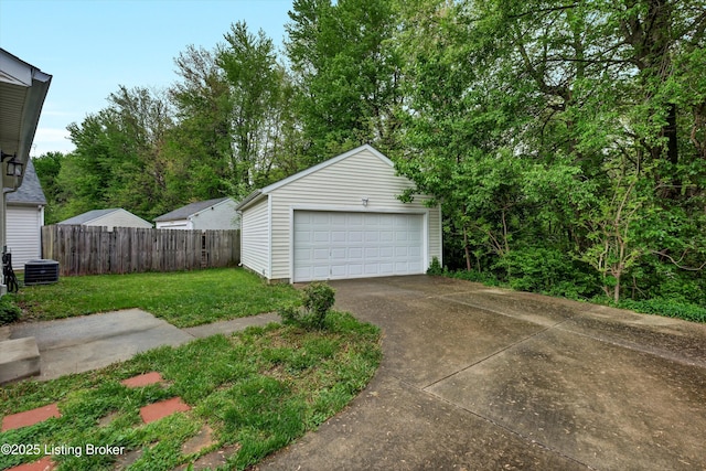 detached garage featuring fence and central AC unit