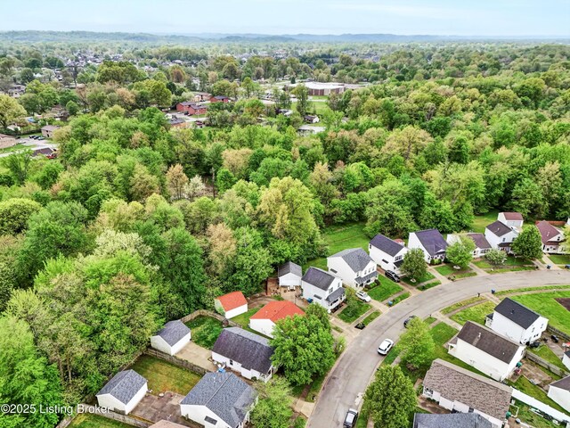 birds eye view of property with a view of trees and a residential view