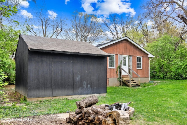 view of outbuilding featuring a fire pit and entry steps