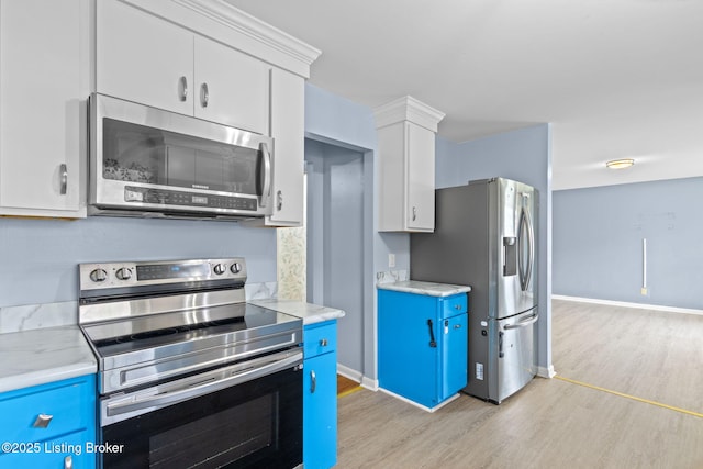 kitchen featuring blue cabinets, appliances with stainless steel finishes, and light wood-type flooring