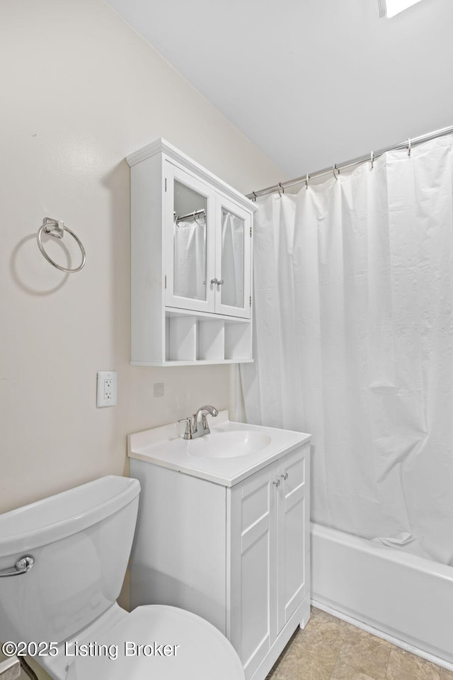 bathroom with toilet, vanity, and shower / bathtub combination with curtain