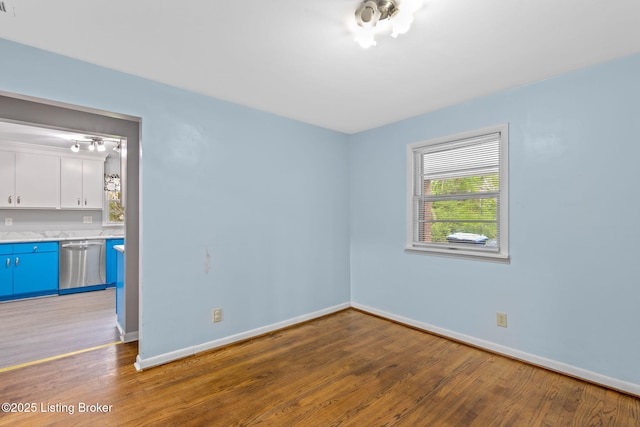 empty room featuring baseboards and wood finished floors