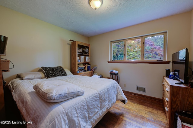 7105 Woodrow Way, Louisville, KY 40228 - bedroom featuring wood finished floors and a textured ceiling