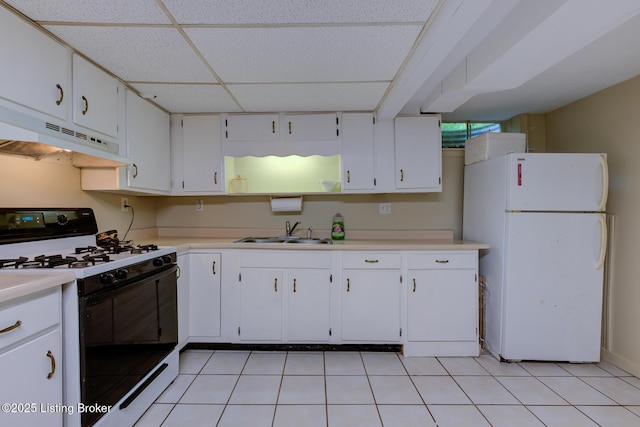 7105 Woodrow Way, Louisville, KY 40228 - kitchen with gas range, freestanding refrigerator, under cabinet range hood, a drop ceiling, and white cabinetry