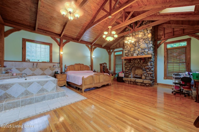 7105 Woodrow Way, Louisville, KY 40228 - bedroom featuring wood-type flooring, a chandelier, wooden ceiling, and a stone fireplace