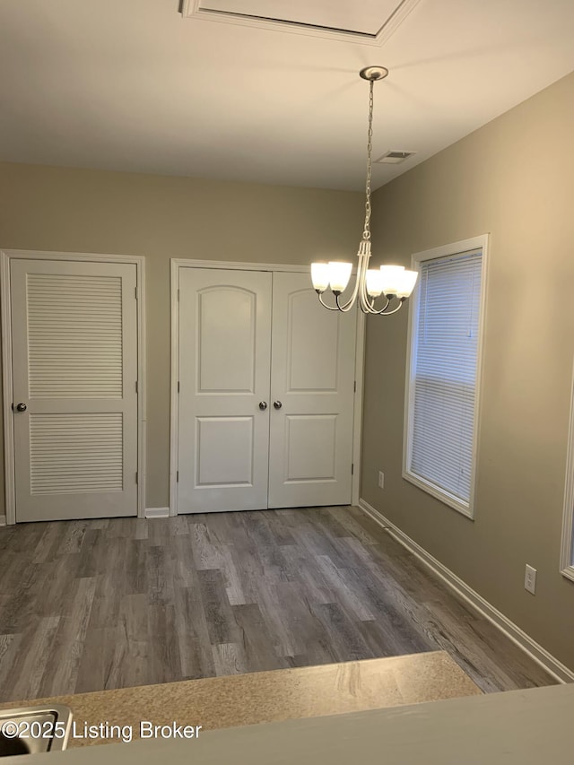 1015 E Muhammad Ali Blvd, Louisville, KY 40204 - unfurnished dining area featuring a chandelier and wood finished floors