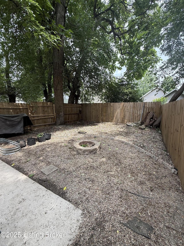 1015 E Muhammad Ali Blvd, Louisville, KY 40204 - fenced backyard featuring an outdoor fire pit