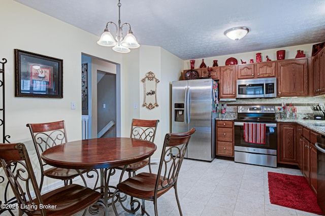 12305 Dominion Way, Louisville, KY 40299 - kitchen featuring a textured ceiling, a chandelier, appliances with stainless steel finishes, light tile patterned floors, and hanging light fixtures