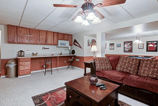 12305 Dominion Way, Louisville, KY 40299 - carpeted living room featuring built in study area, baseboards, a ceiling fan, and a drop ceiling