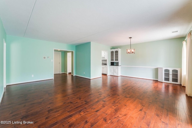 5100 US Highway 42 Unit 226, Louisville, KY 40241 - unfurnished living room featuring a chandelier, dark wood-type flooring, and baseboards